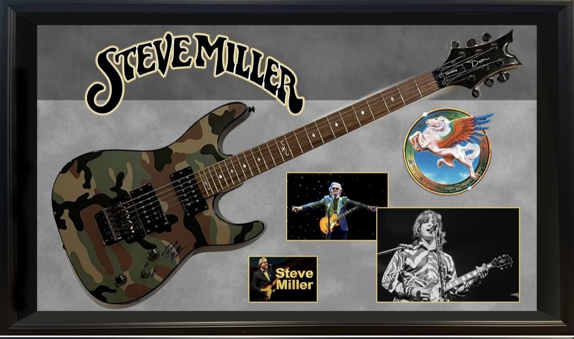 Camouflage guitar with Steve Miller memorabilia display.