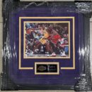 Framed basketball photo of two players.