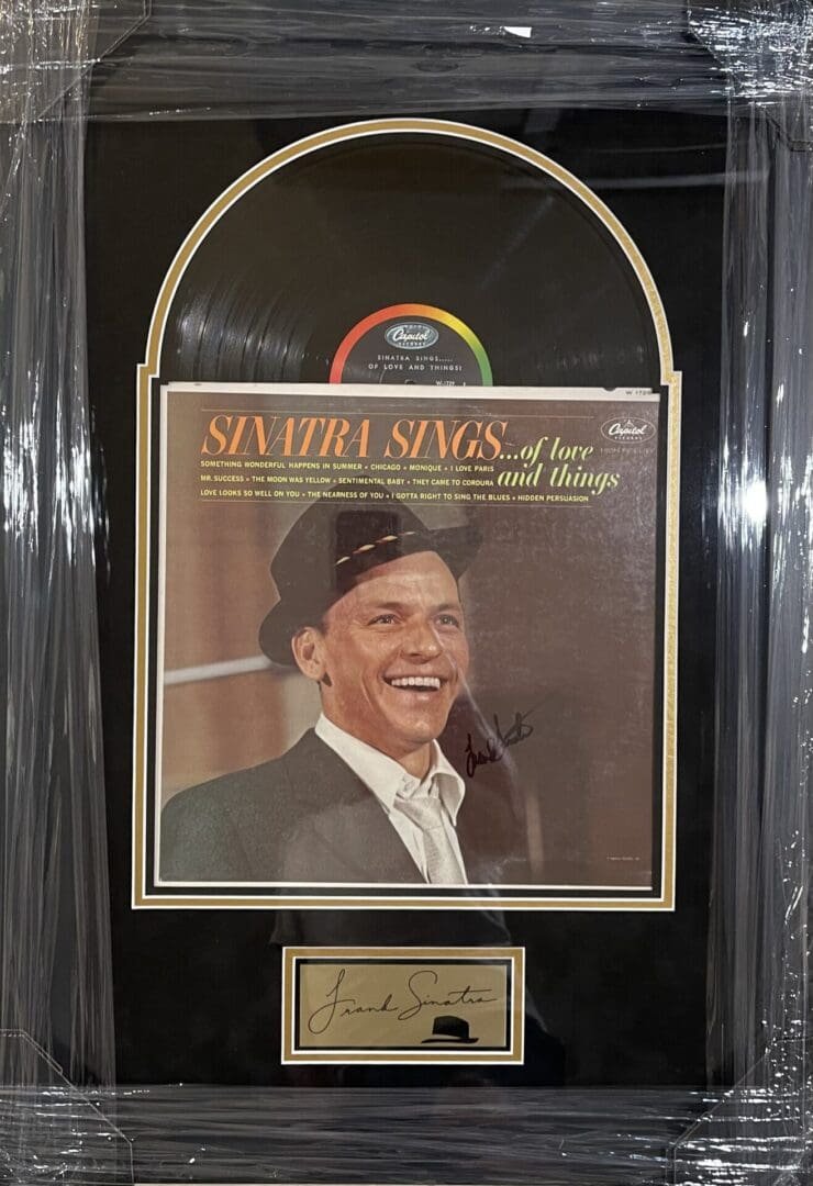 Framed Sinatra album and signature display.
