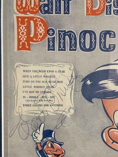 Vintage Pinocchio poster with autograph and lyrics.