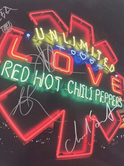 Neon sign reading "Unlimited Love" with signatures.