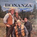 Four men in Western attire outdoors.