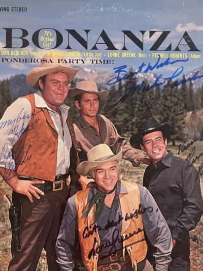 Four men in Western attire outdoors.