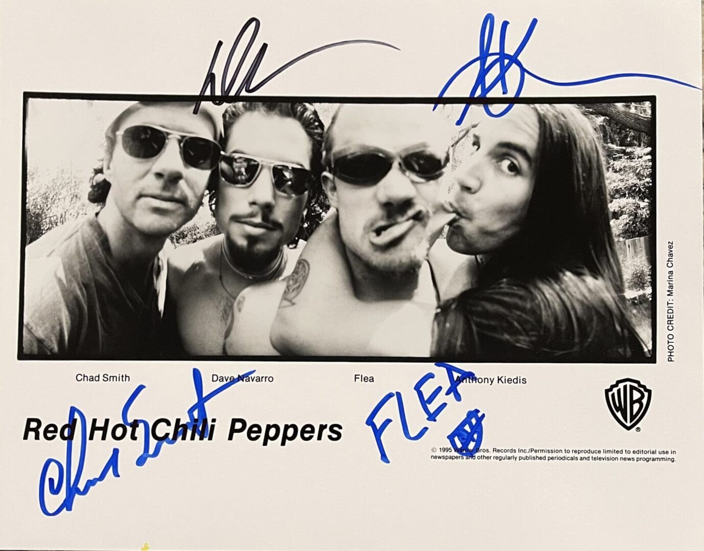 Black and white band photo with signatures.