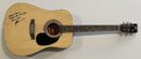 Acoustic guitar with a signed message.