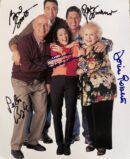 Group of five people hugging and smiling.