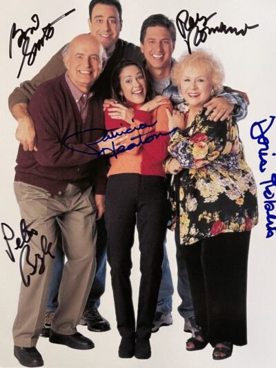 Group of five people hugging and smiling.