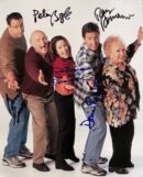Five people posing with autographs on photo.