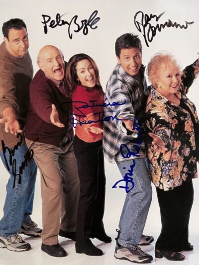 Five people posing with autographs on photo.