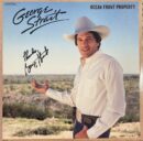 Man in cowboy hat in open field.