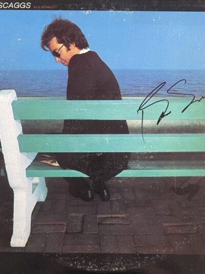 Man sitting on bench by the sea.