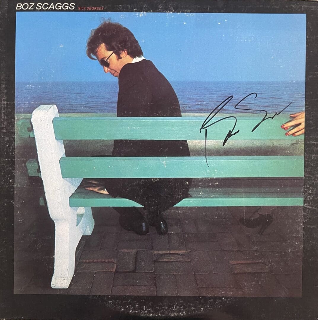 Man sitting on bench by the sea.