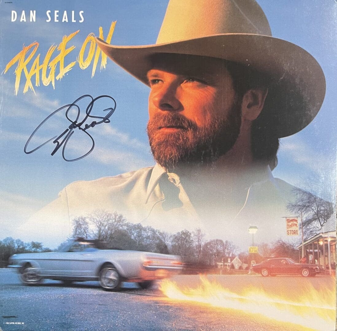 Man in cowboy hat with burning car.