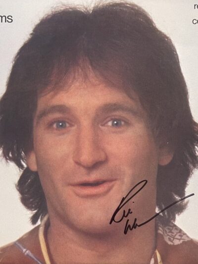 A person smiling on an album cover.