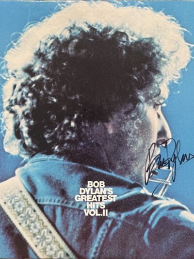 Musician with guitar on blue album cover.