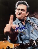 Man with guitar making a gesture.