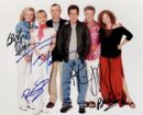 Group of six people standing together smiling.