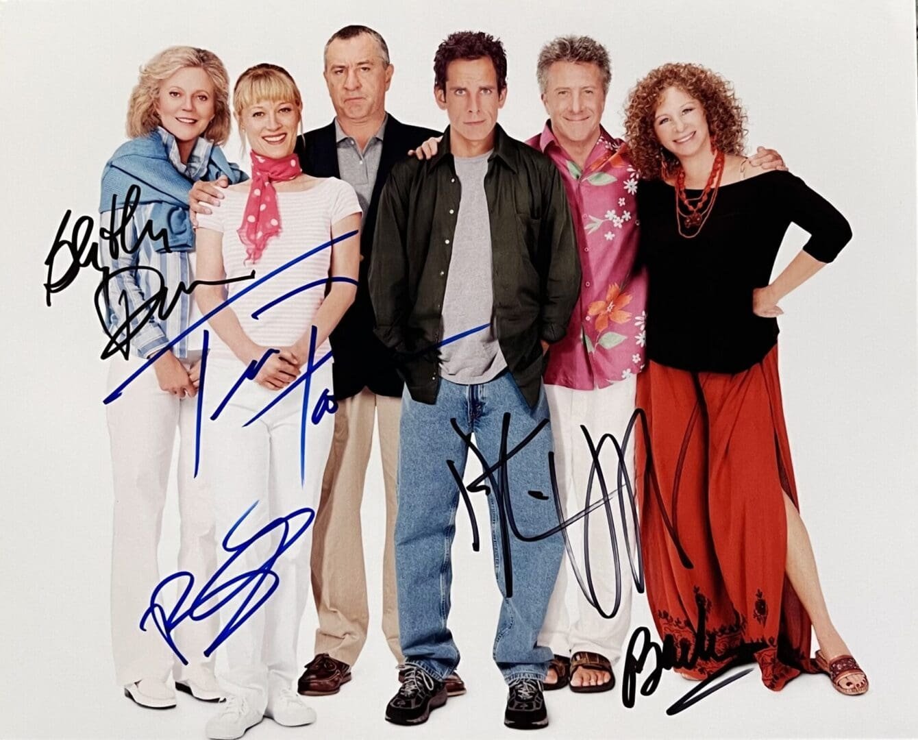 Group of six people standing together smiling.