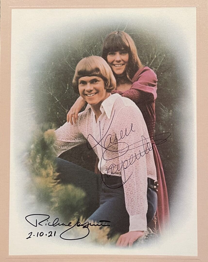 Two people smiling in a vintage portrait.