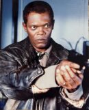 Man in leather jacket holding a gun.