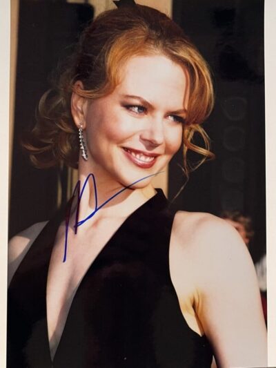 Smiling woman in elegant black dress.
