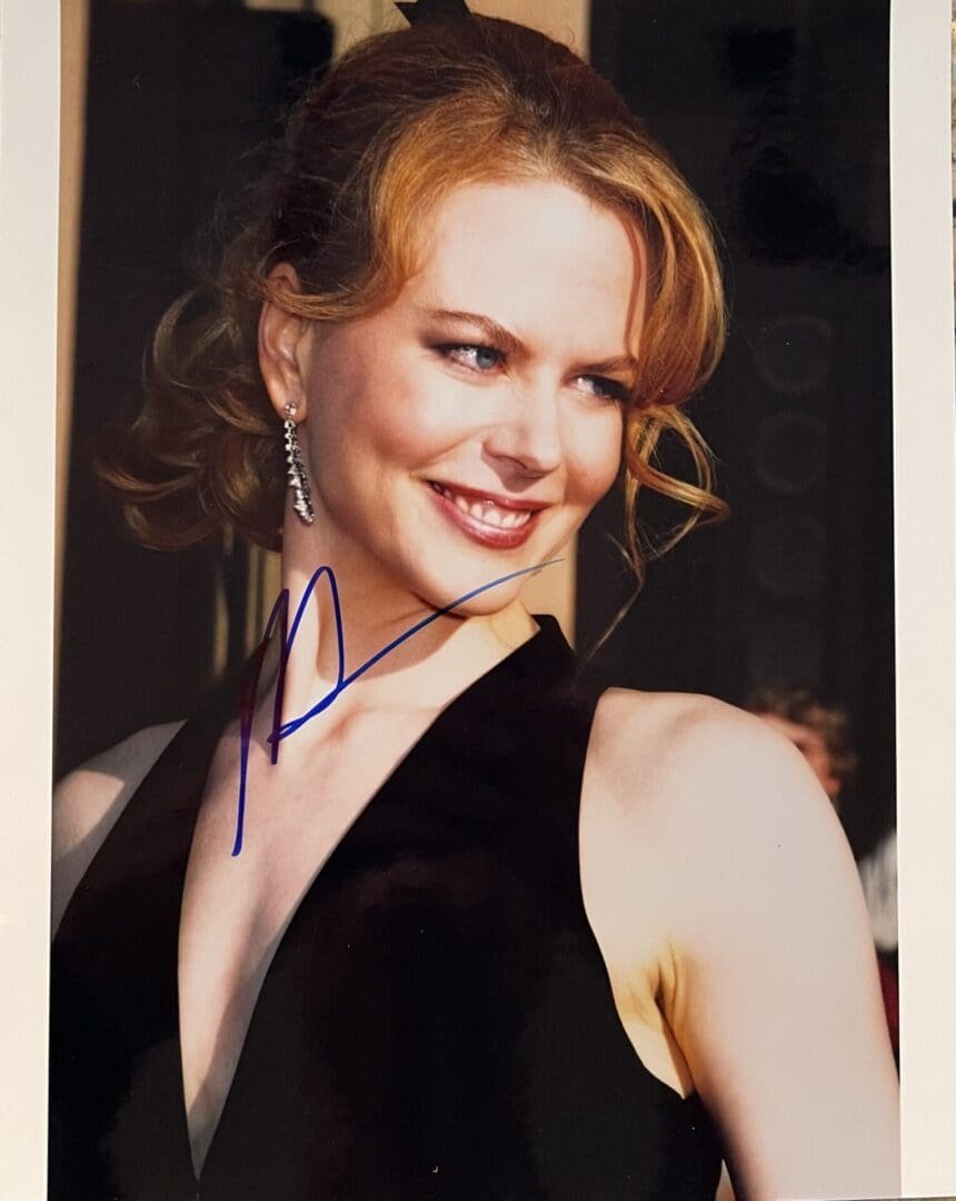 Smiling woman in elegant black dress.