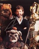 Man with Ewoks and robot characters posing.