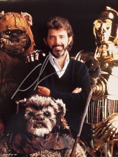 Man with Ewoks and robot characters posing.