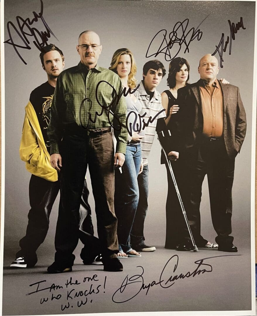Cast photo with multiple autographs and signatures.