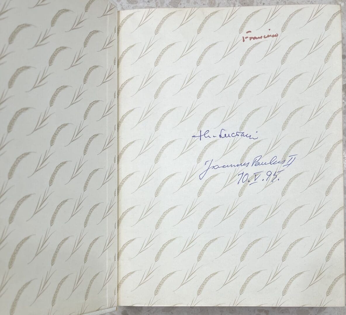 Open book with handwritten notes inside cover.