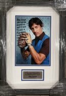 Framed autograph photo of a man posing.