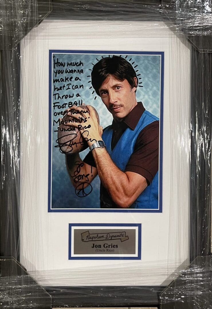 Framed autograph photo of a man posing.