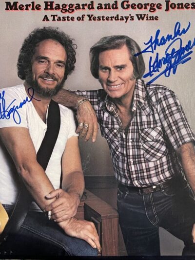 Two men posing with a guitar.