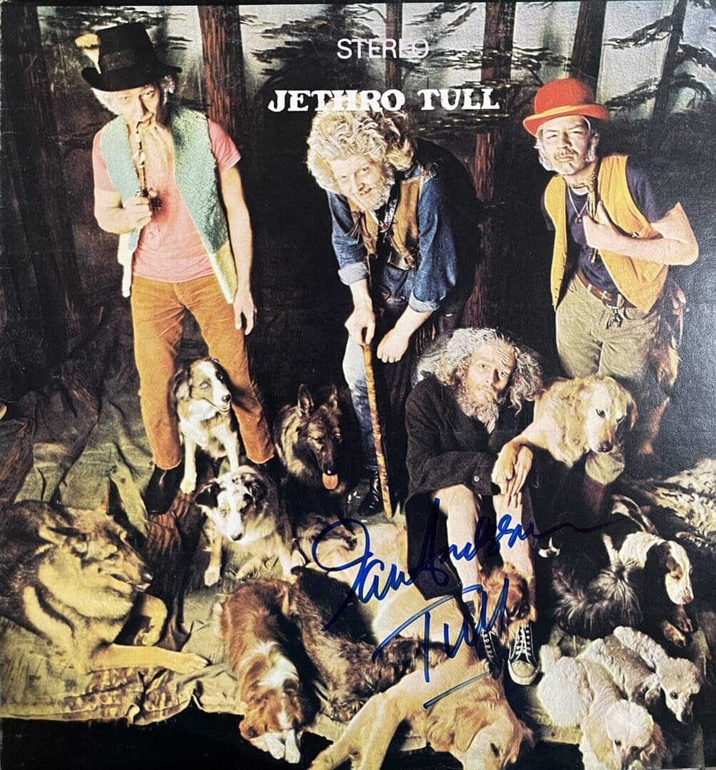 Band members with dogs in rustic setting.
