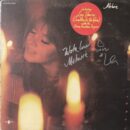 Album cover with woman and candles.