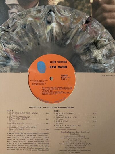 Marbled vinyl record with album cover.