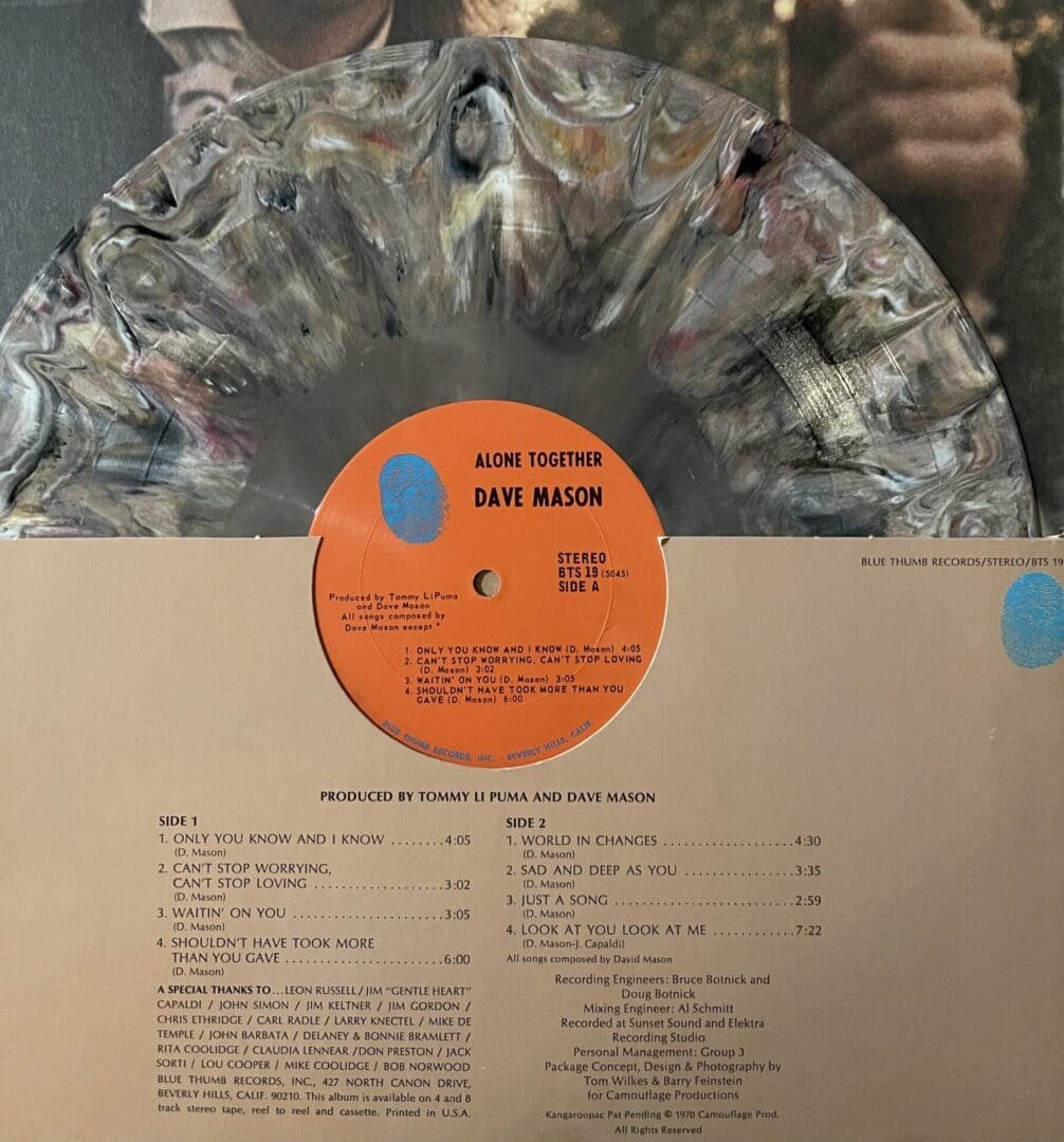 Marbled vinyl record with album cover.