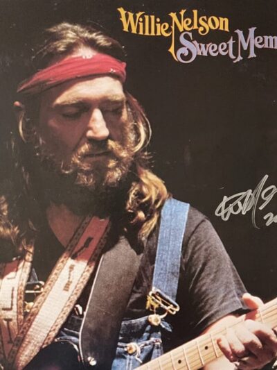 Musician playing guitar on album cover.