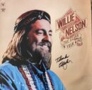 Smiling man on album cover with autograph.