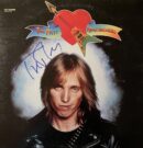 Album cover with signed autograph and guitar.