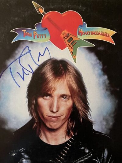 Album cover with signed autograph and guitar.