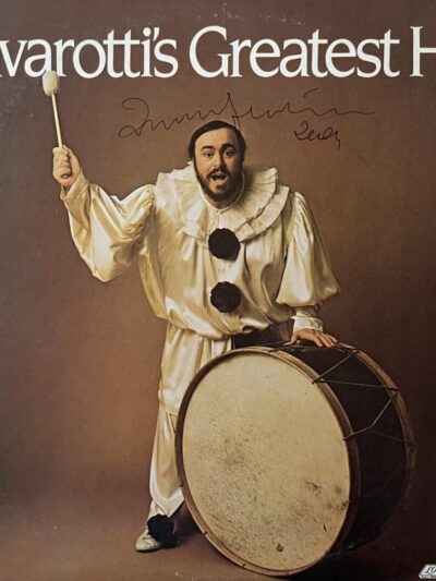 Man in clown costume with a drum.