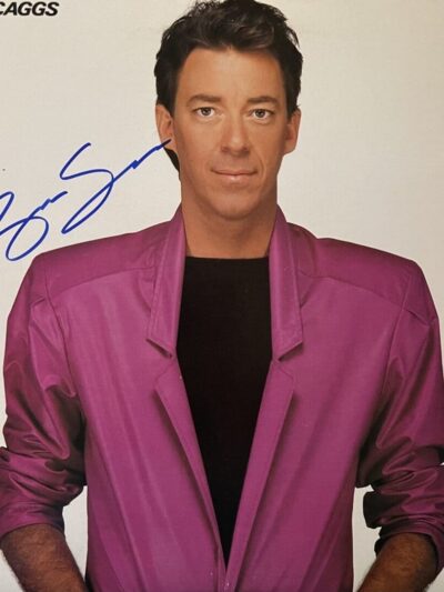 Man in pink jacket with signature.