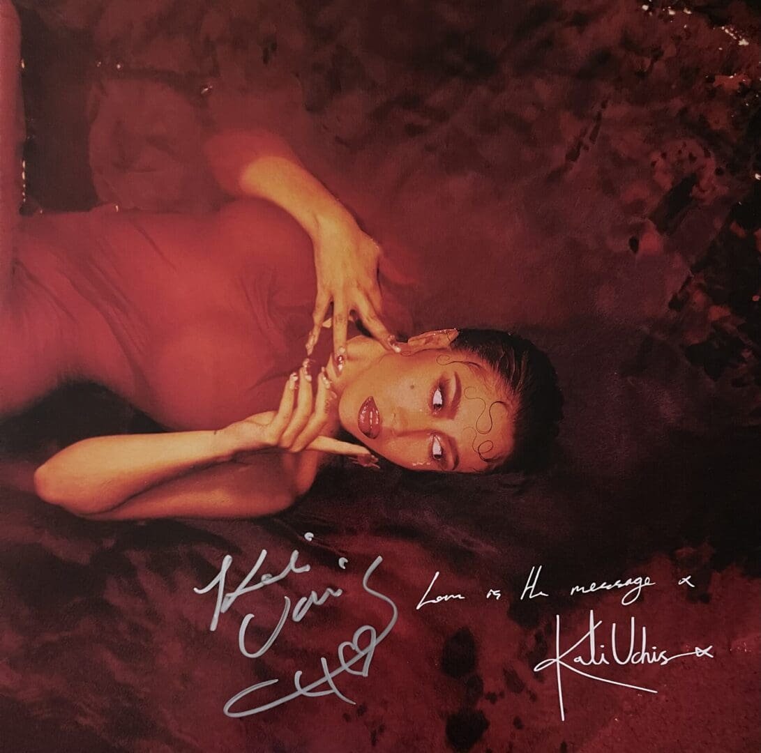 Woman in red dress lying on floor.
