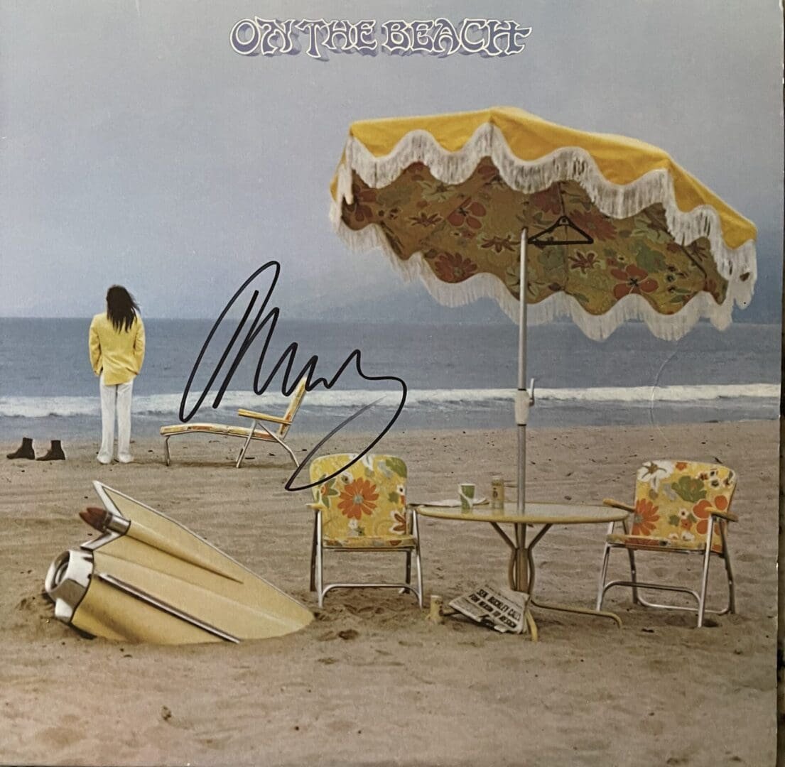 Beach scene with umbrella and chairs.