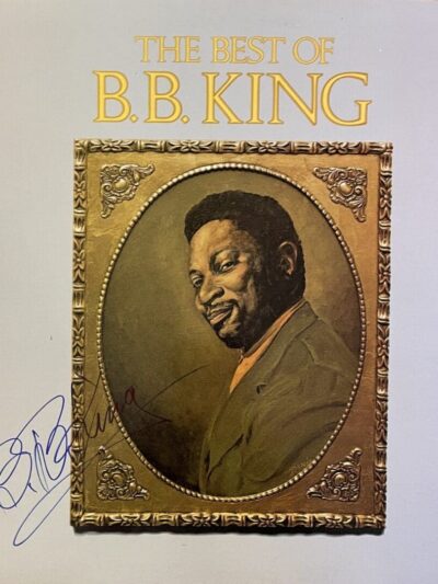 Album cover with portrait and signature.