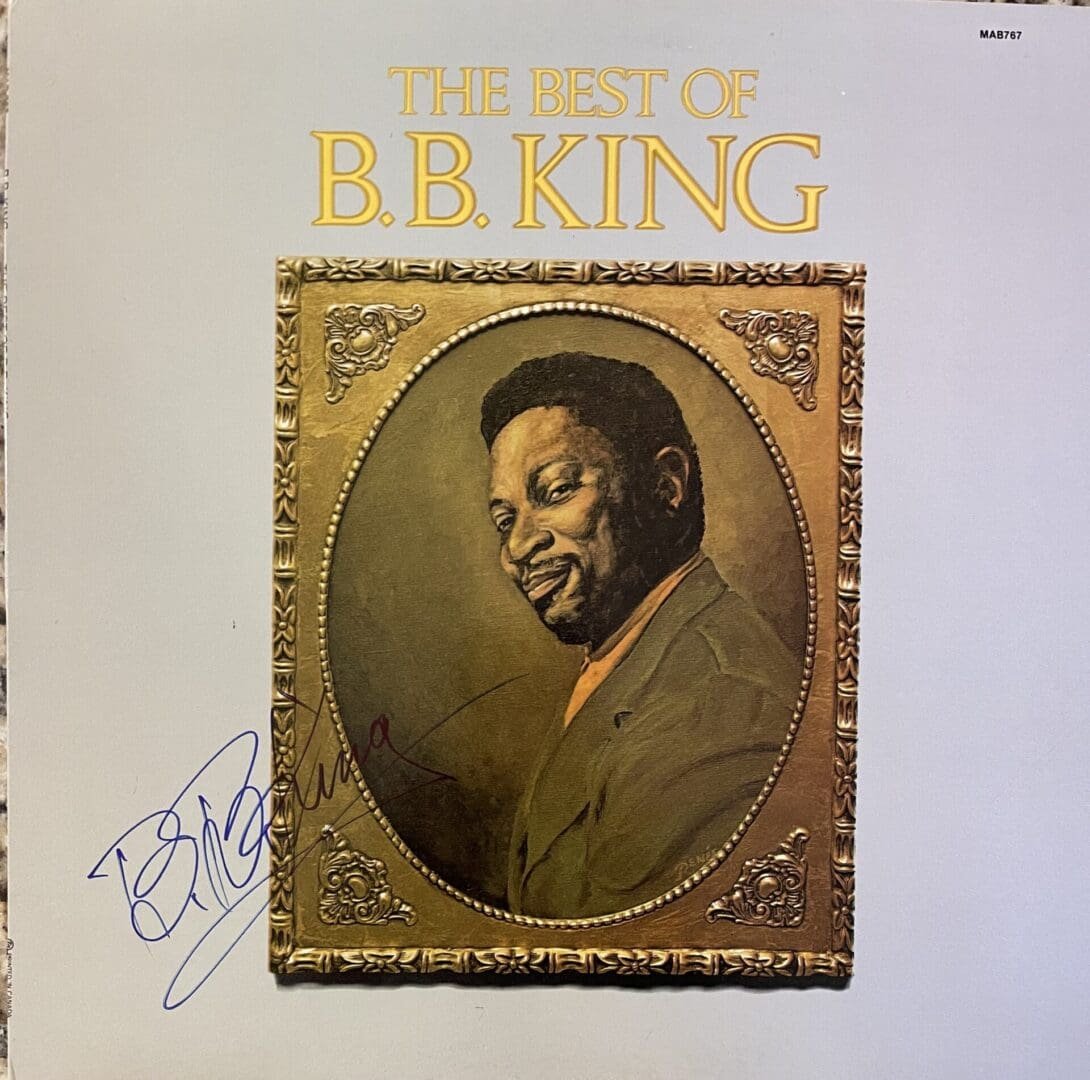 Album cover with portrait and signature.