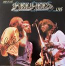 Bee Gees performing live on stage.