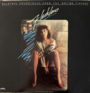 Flashdance soundtrack cover with seated woman.
