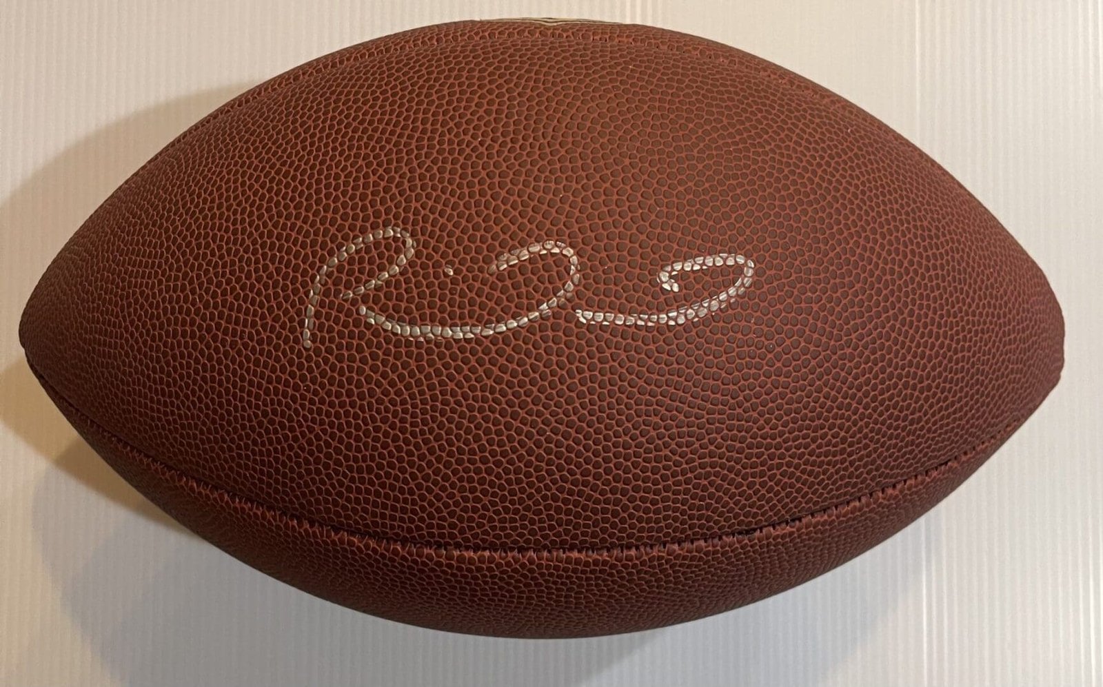 Signed football with a white background.